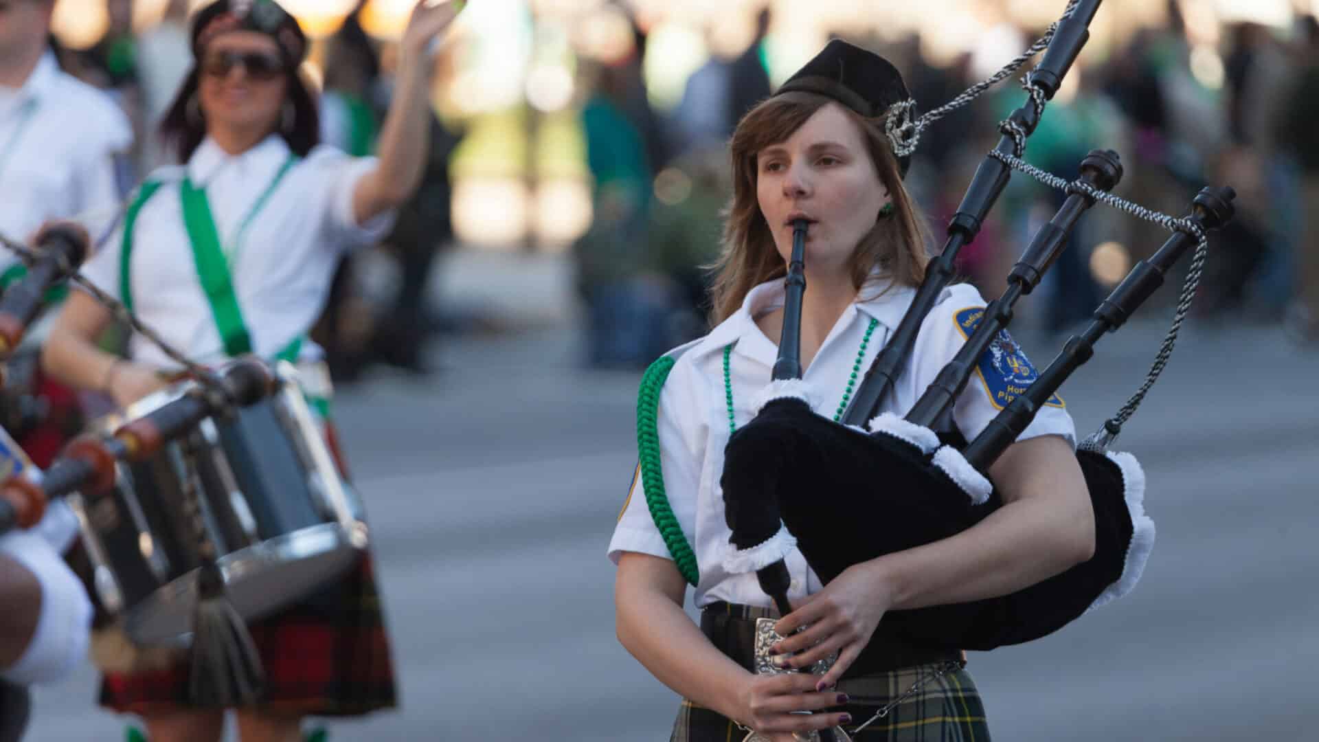 Woman plays traditional irish instrument in Saint Patrick's Day parade