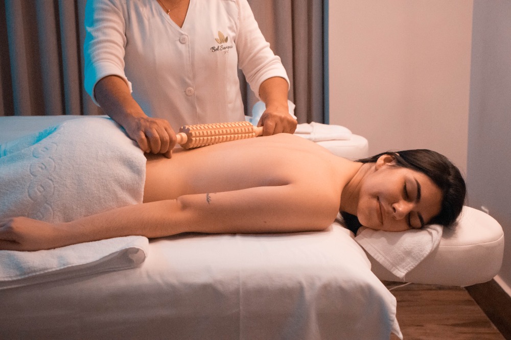 Spa Roller Back Massage Woman on Massage Table