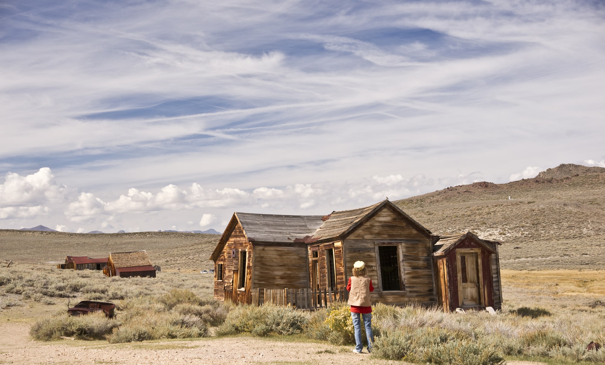 A woman photographer shoots the ruins of an old California ghost town