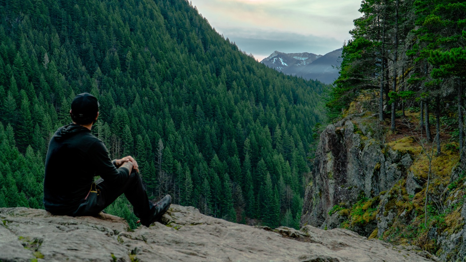 Man sitting on rocks looking out at view from Little Si, WA