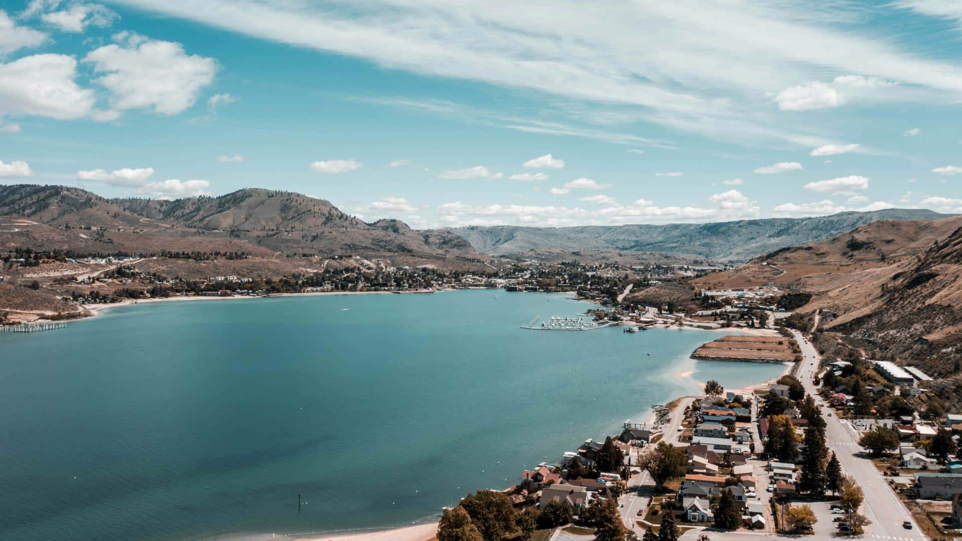 Aerial view of a small town in a valley around a small lake